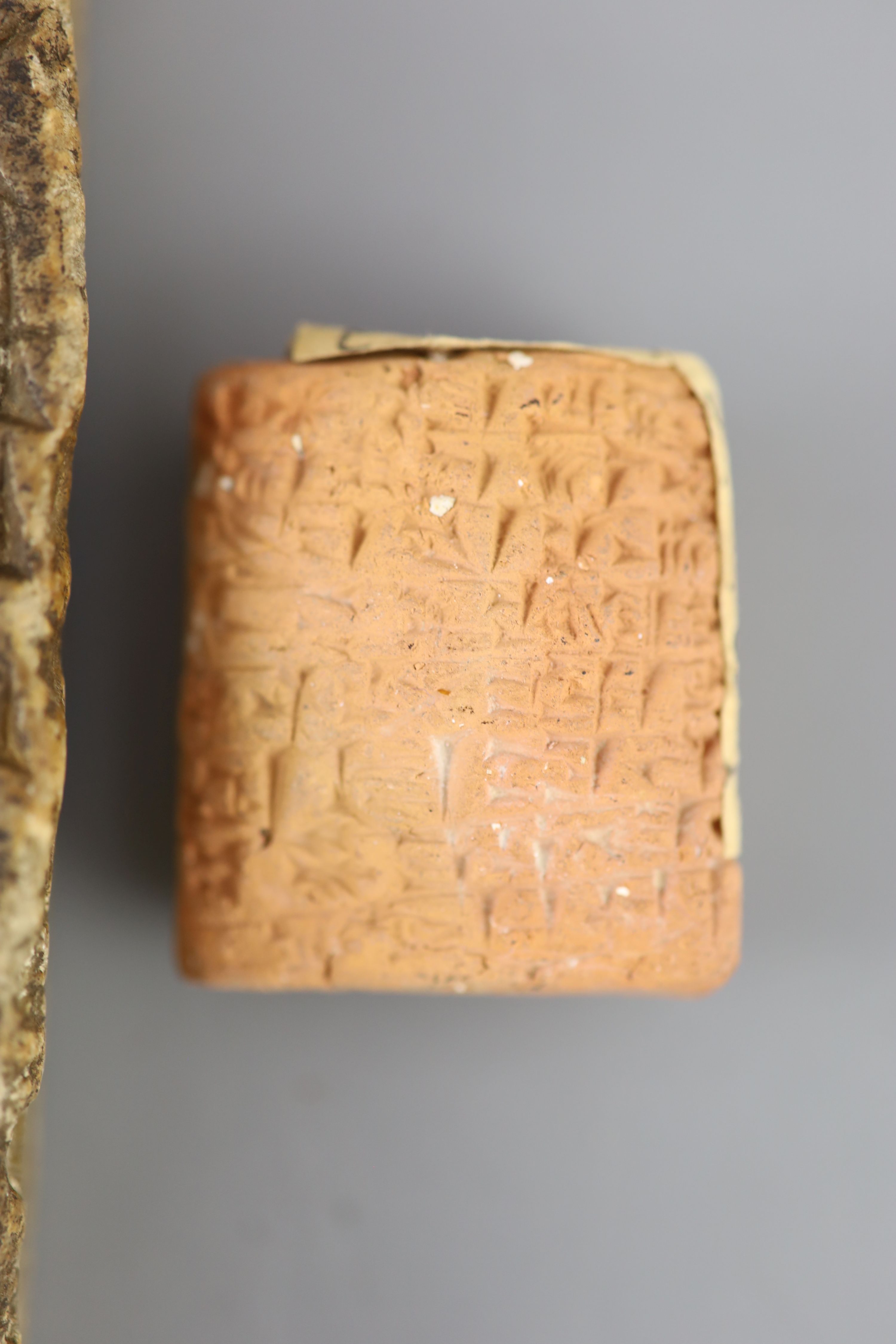 An Ancient Assyrian fragment of a cuneiform alabaster slab, probably 9th century BC from Kouyunjik (Nineveh) and two clay cuneiform tab